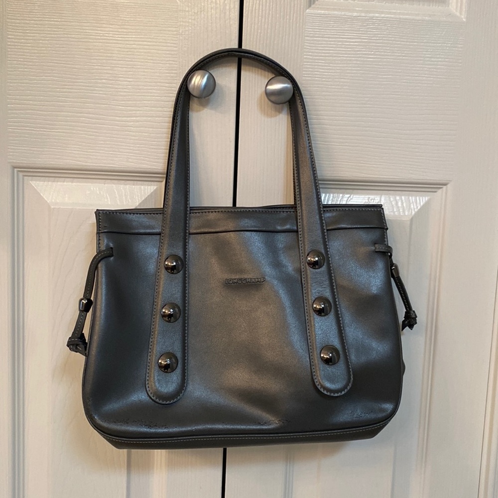 Longchamp bag authentic little wear but some discoloration from being stored.